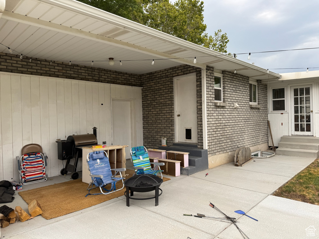 View of patio featuring an outdoor fire pit and entry steps