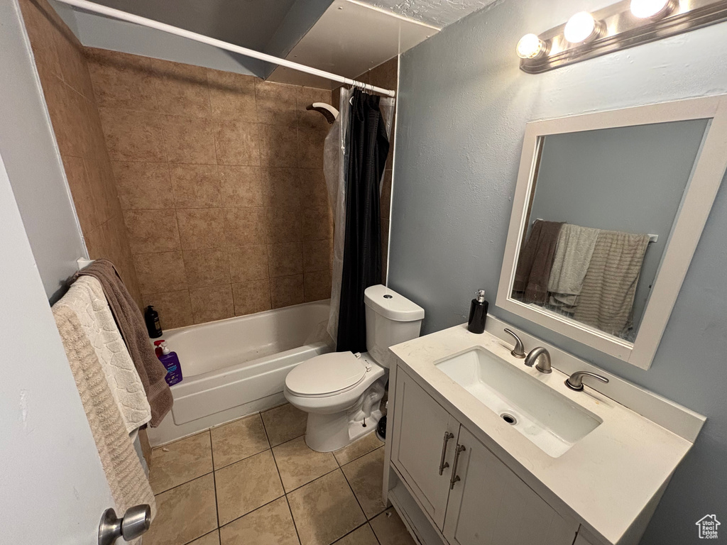 Bathroom with vanity, tile patterned flooring, and shower / bath combo with shower curtain