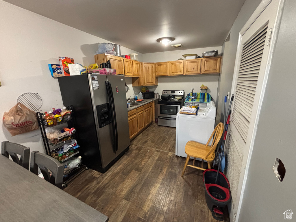 Kitchen featuring dark wood-type flooring, stainless steel appliances, and brown cabinets
