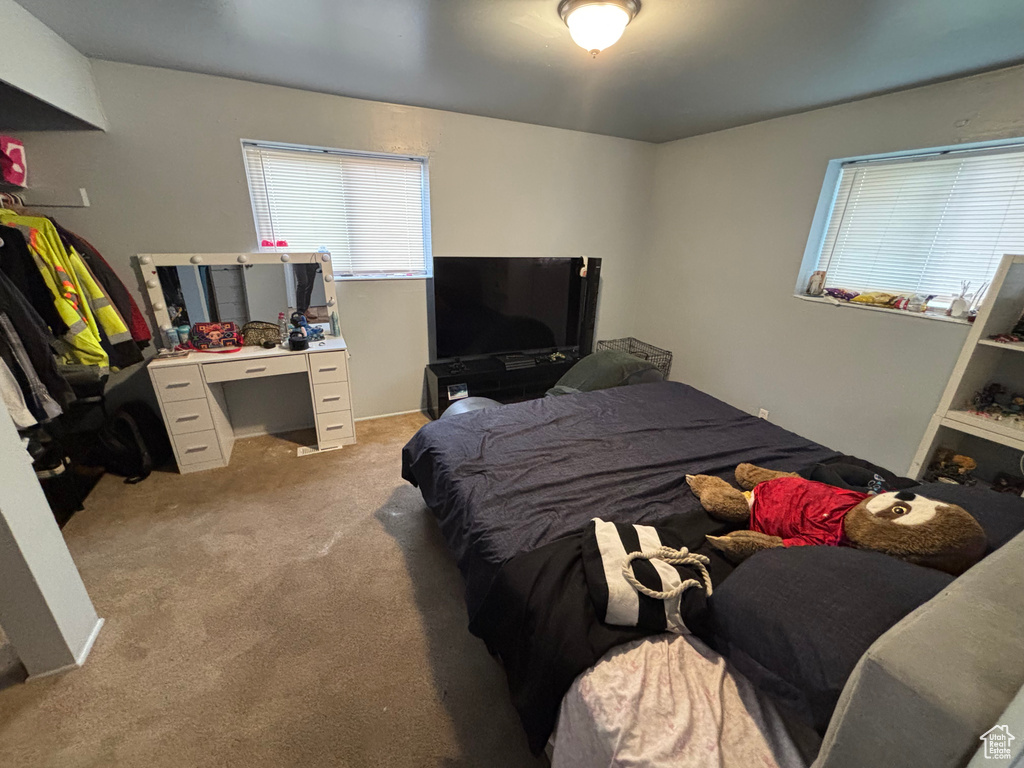 Bedroom featuring light colored carpet