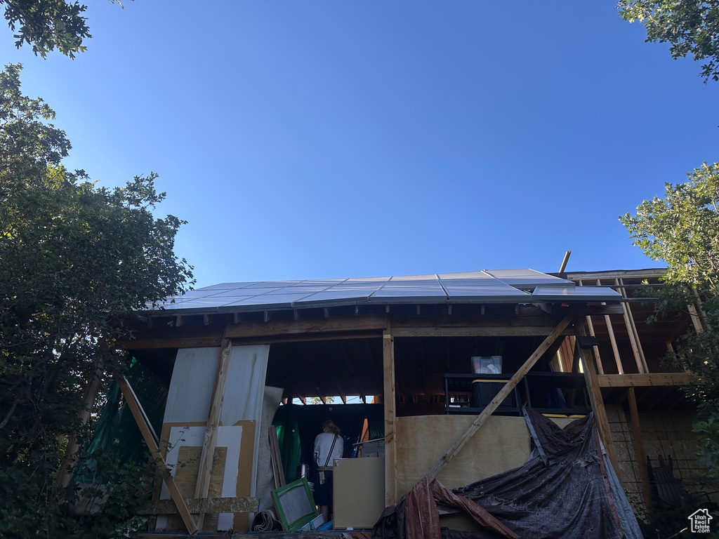Back of property with an outdoor structure