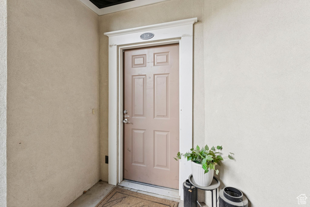 Property entrance featuring stucco siding