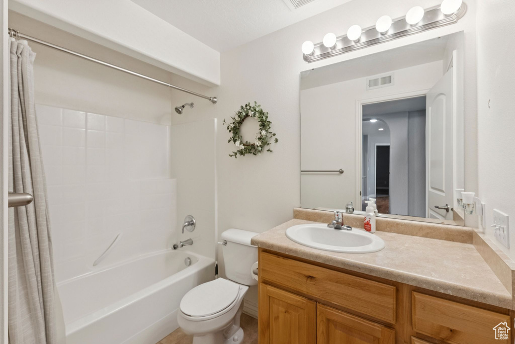 Full bath featuring shower / tub combo and vanity