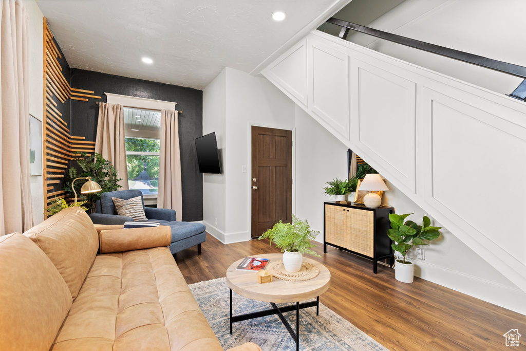 Living area featuring wood finished floors and recessed lighting