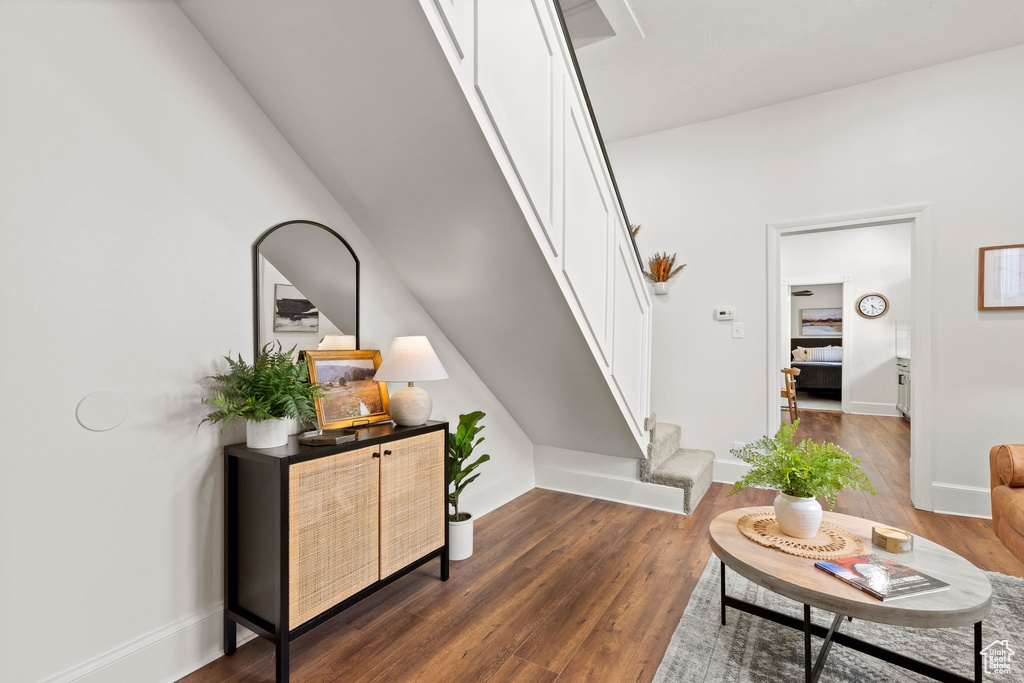 Living area with stairs and dark wood finished floors