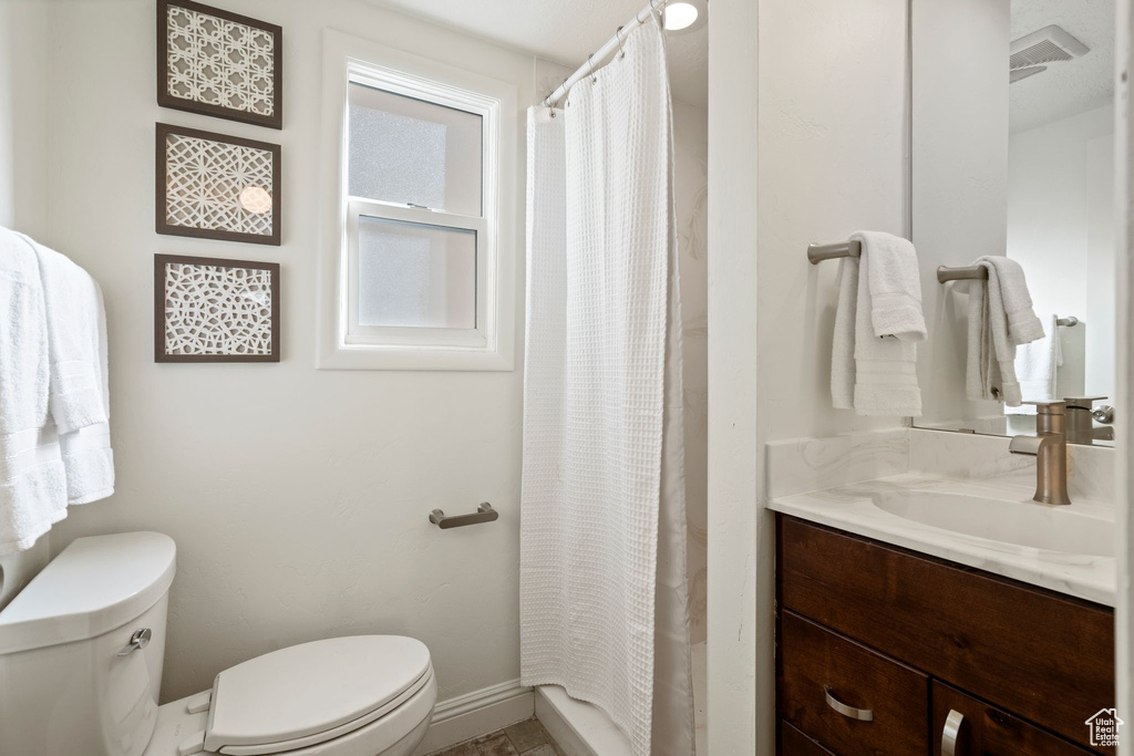Bathroom featuring vanity and curtained shower