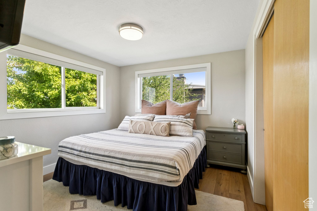 Bedroom featuring wood finished floors and baseboards