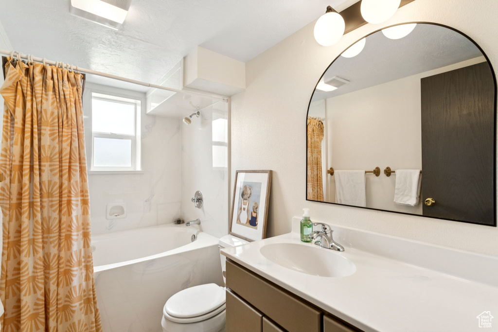 Bathroom featuring vanity and shower / tub combo with curtain