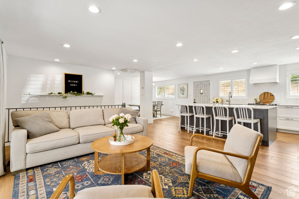 Living room featuring recessed lighting, light wood-style flooring, and healthy amount of natural light