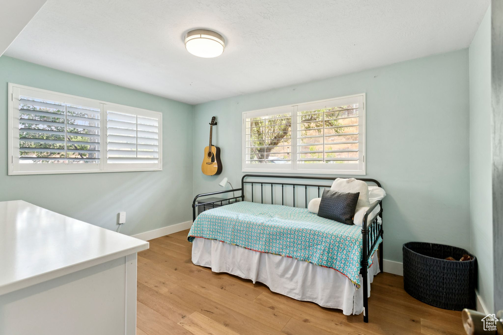 Bedroom with light wood-type flooring and baseboards