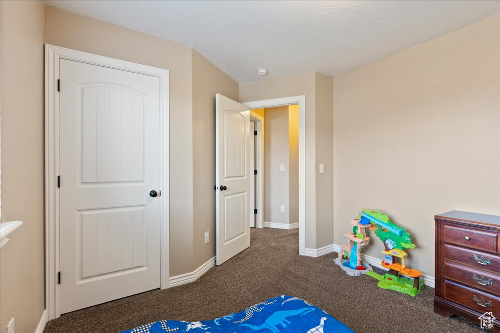 Carpeted bedroom with baseboards
