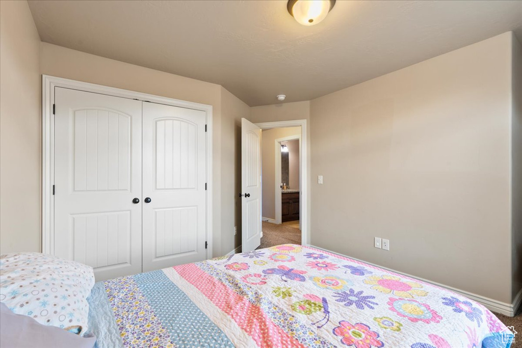 Bedroom featuring carpet floors and a closet