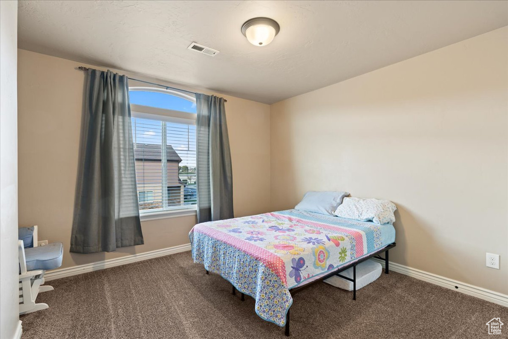 Carpeted bedroom with baseboards