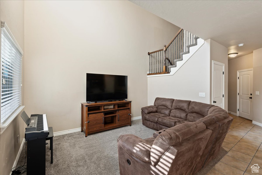 Living area with baseboards and stairway