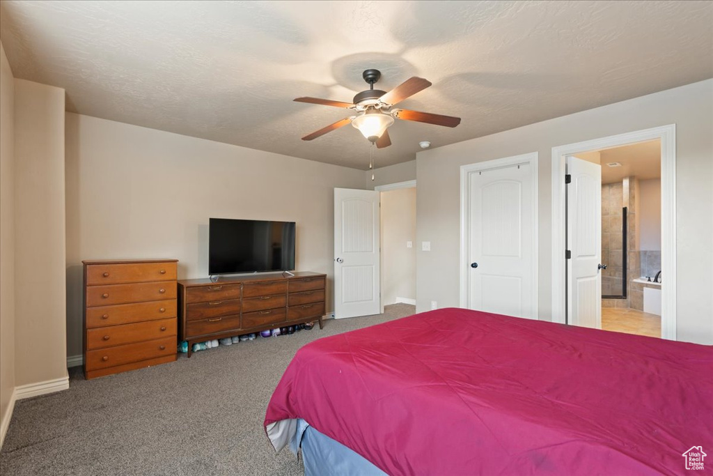 Bedroom with ensuite bath, carpet, and a ceiling fan