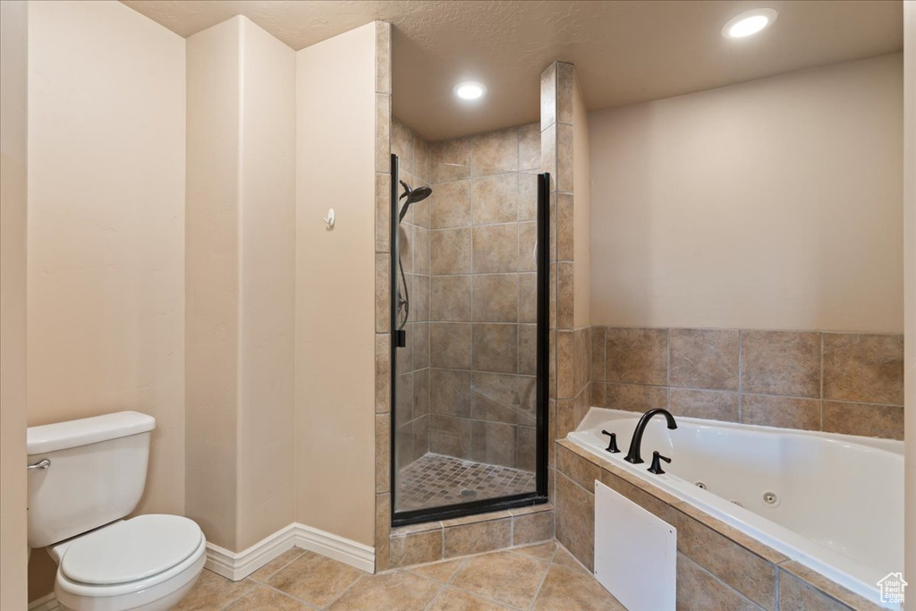 Bathroom featuring a whirlpool tub, a stall shower, tile patterned floors, and recessed lighting