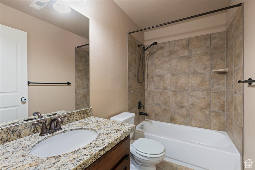 Bathroom featuring vanity, bathtub / shower combination, and tile patterned flooring