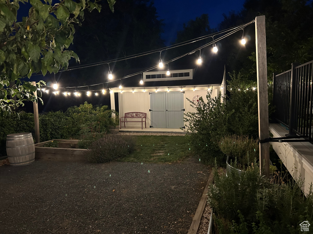 Yard at night with a garden and an outbuilding