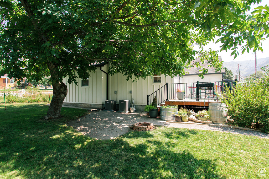 View of grassy yard with a fire pit