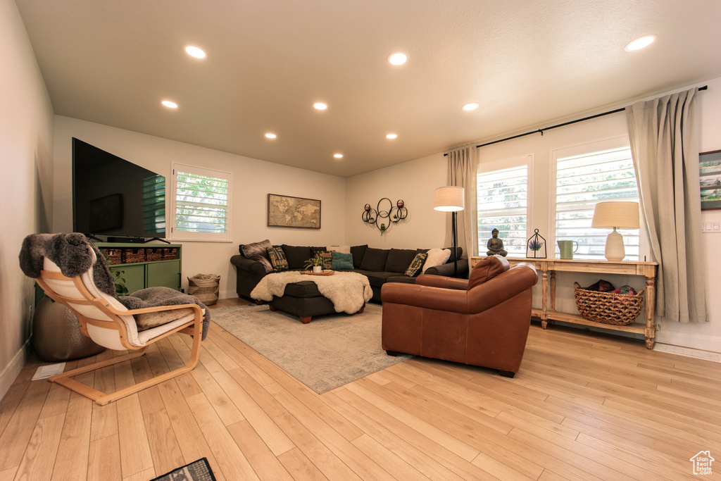 Living area featuring light wood-type flooring and recessed lighting