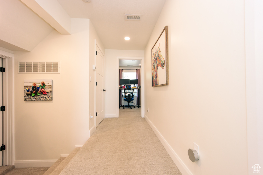 Hallway featuring light colored carpet and recessed lighting