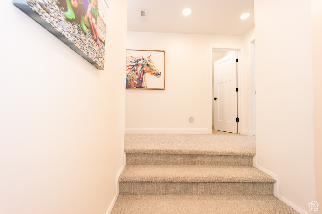 Stairway featuring carpet flooring and recessed lighting
