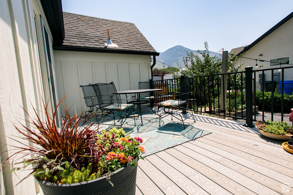 Deck with a mountain view and outdoor dining area