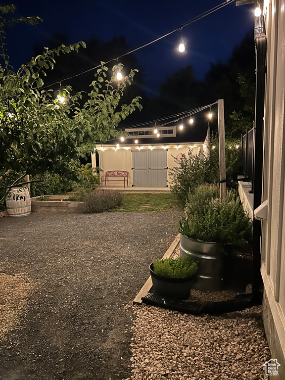 Yard at night with an outbuilding