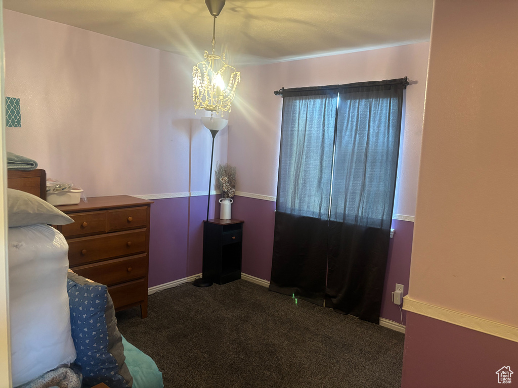 Carpeted bedroom with a chandelier