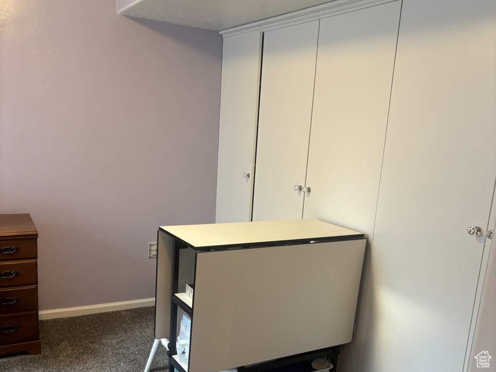 Bedroom with carpet, a textured ceiling, and a closet