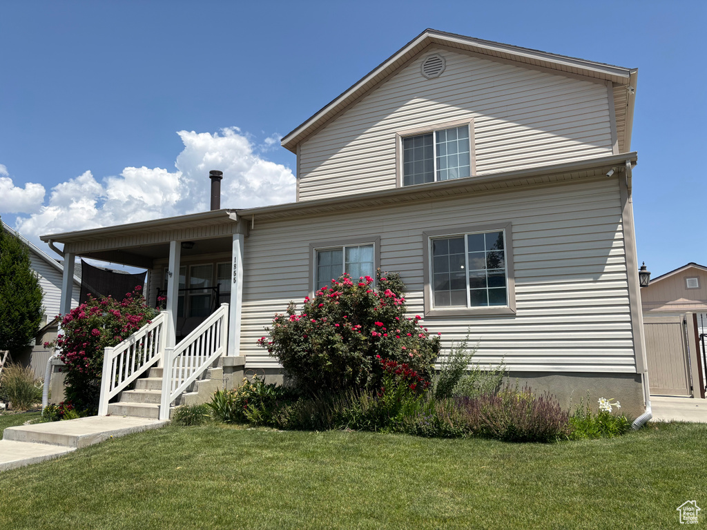 View of front of property with a front lawn