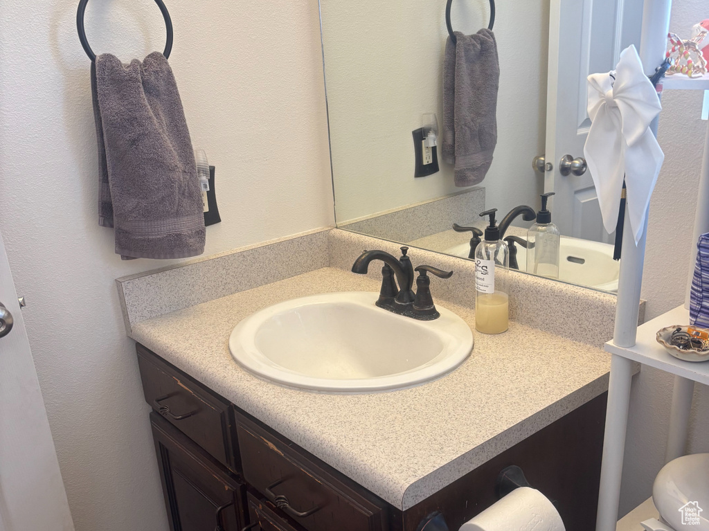 Bathroom featuring vanity and toilet