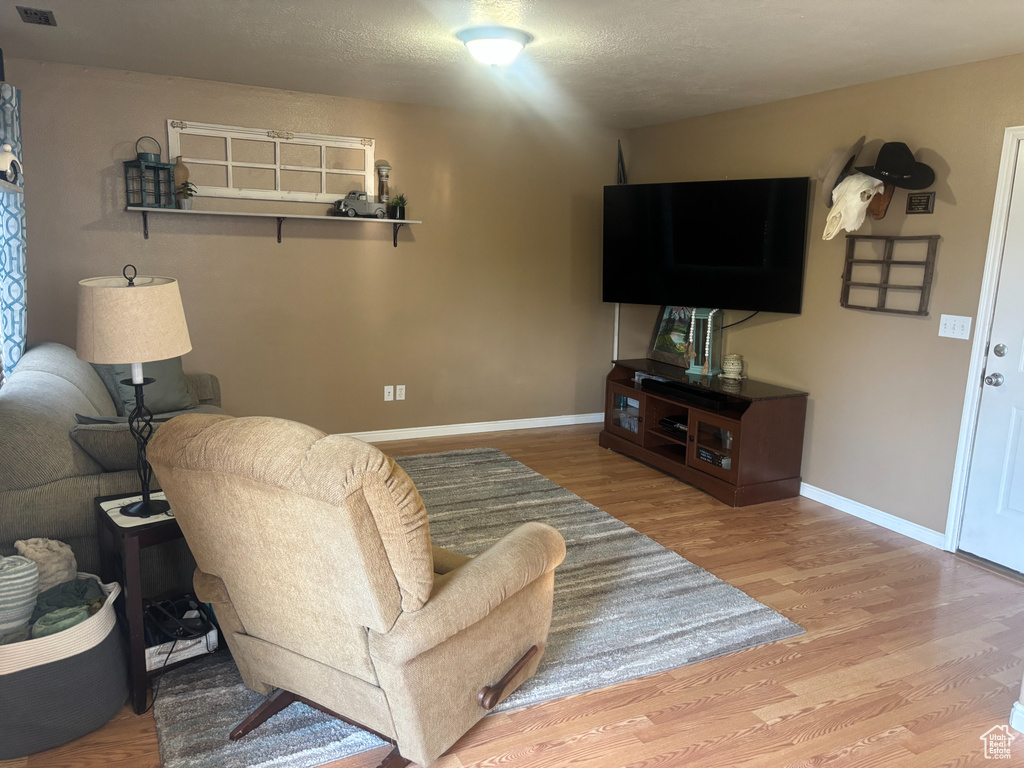 Living room featuring wood finished floors and baseboards