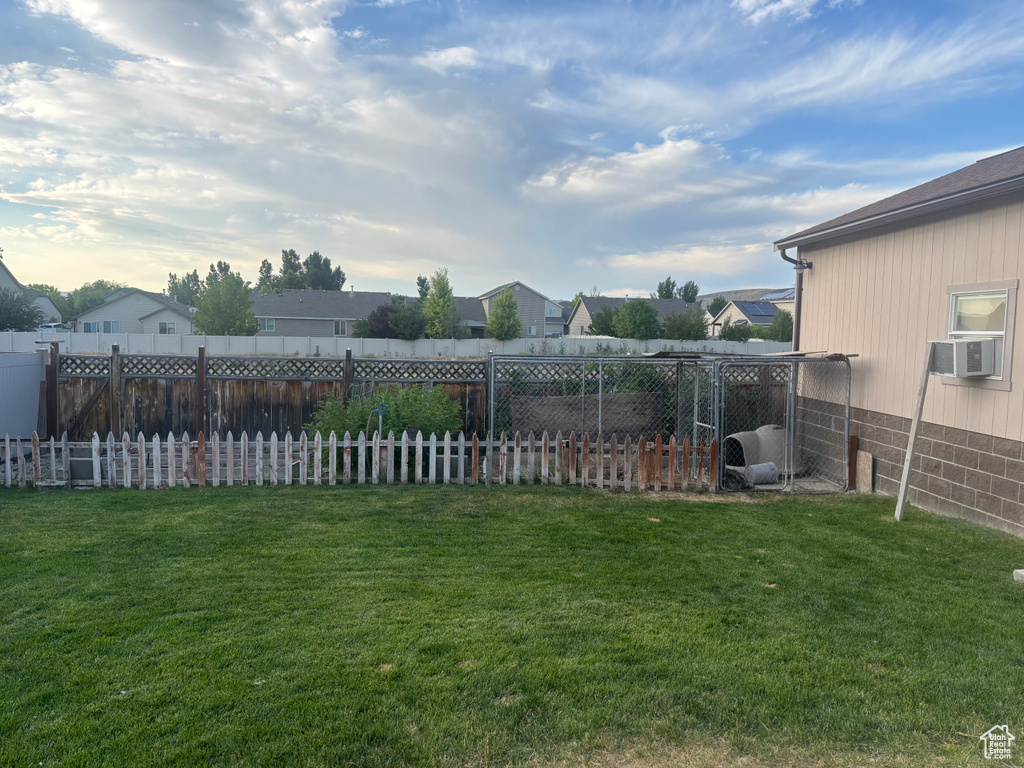 Fenced backyard featuring a residential view