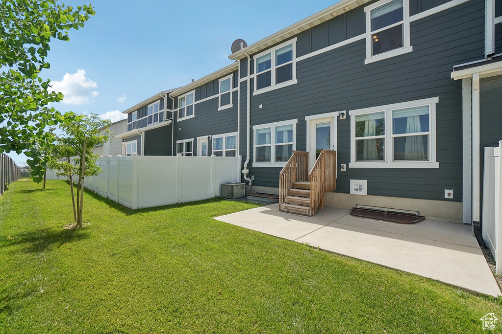 Rear view of house with a patio and board and batten siding
