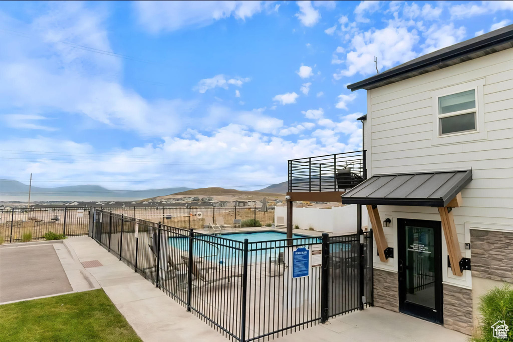 Community pool featuring a mountain view and a patio