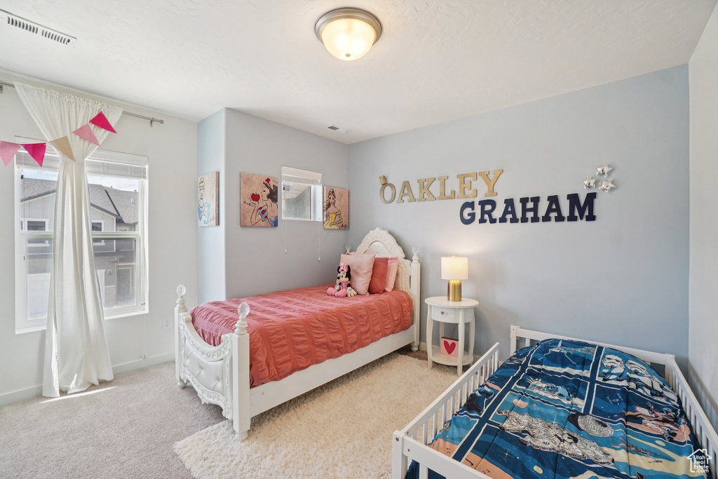 Carpeted bedroom featuring baseboards
