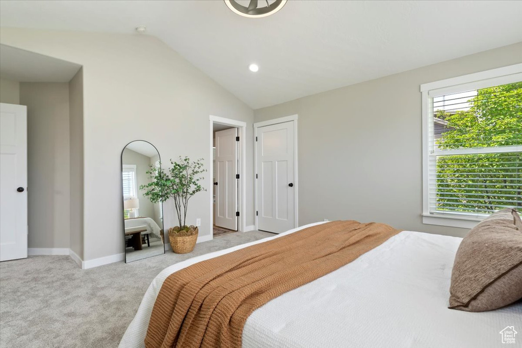 Bedroom with multiple windows, carpet floors, vaulted ceiling, and recessed lighting