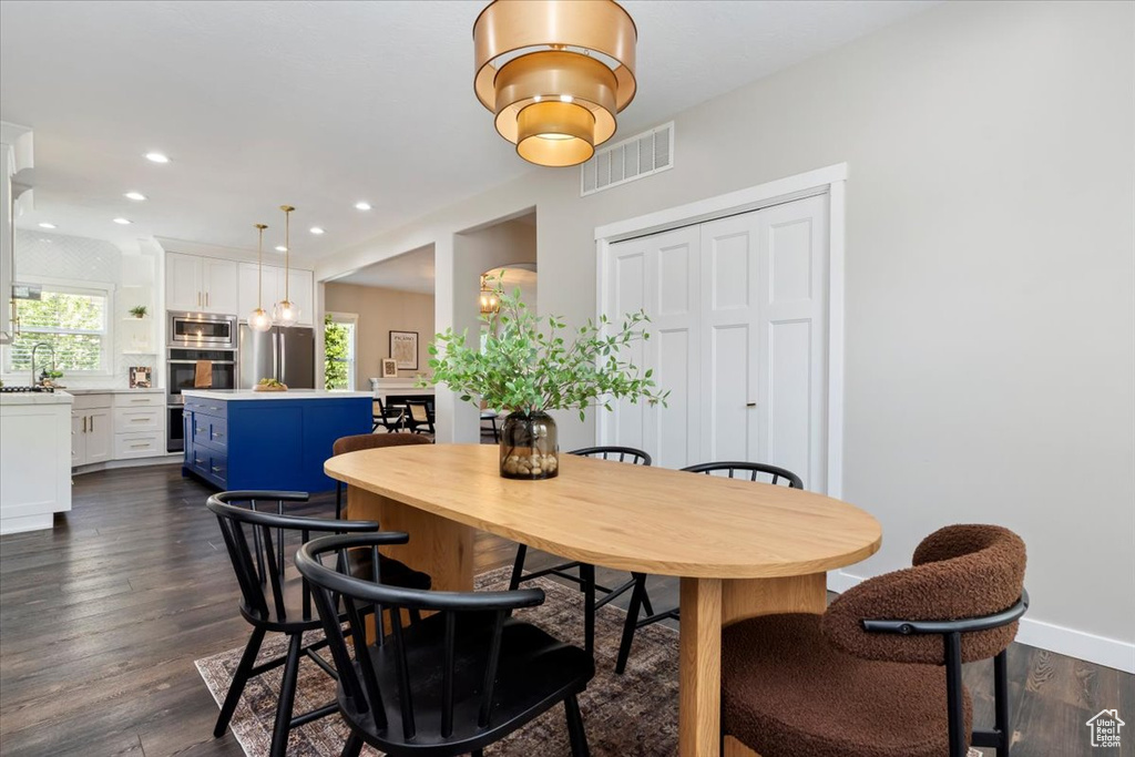 Dining room featuring dark wood-style flooring and recessed lighting