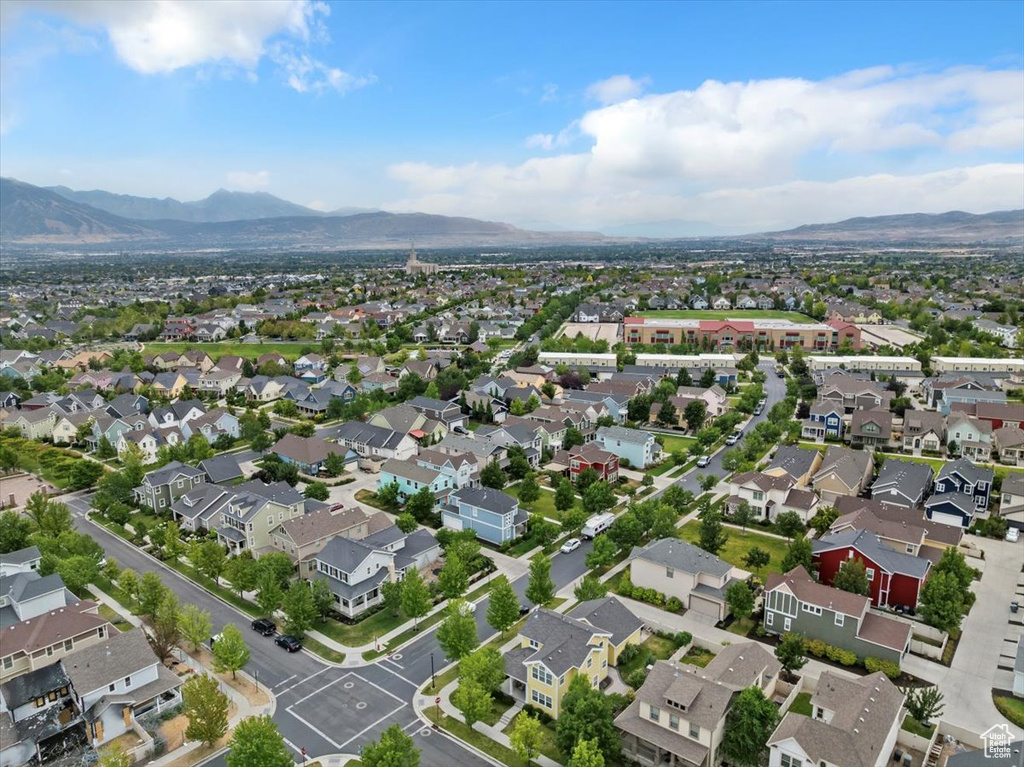 Aerial view of property's location with a mountainous background and nearby suburban area