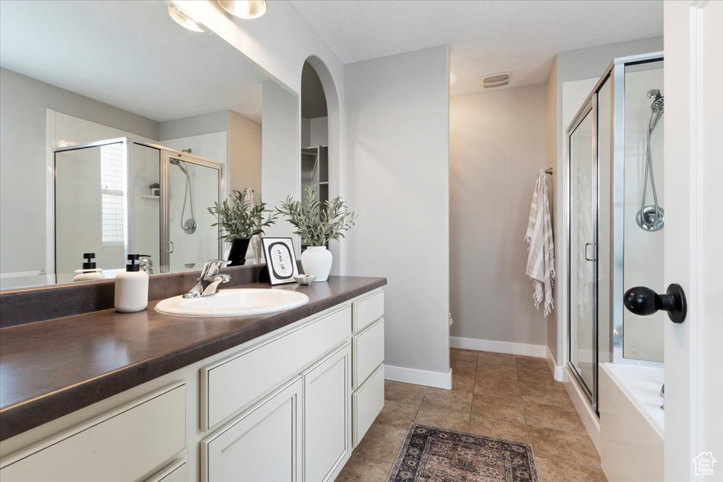 Bathroom with vanity, a shower stall, and a tub