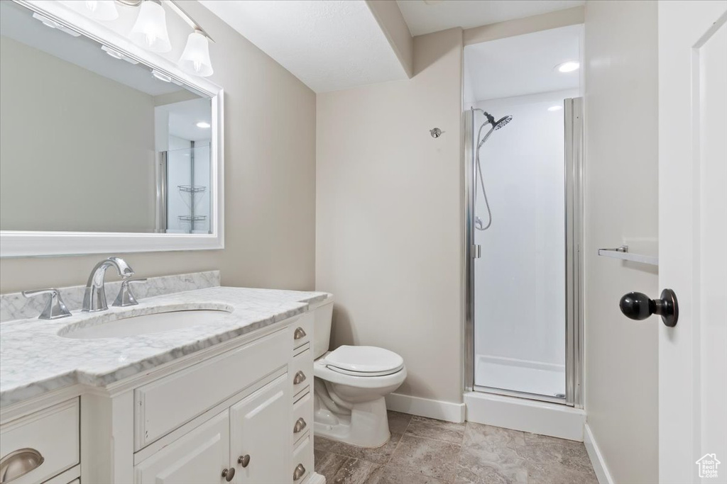 Bathroom featuring a stall shower and vanity