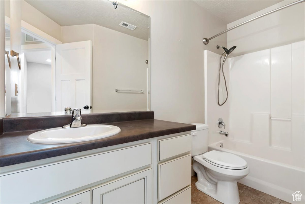 Full bathroom with vanity, washtub / shower combination, and tile patterned floors