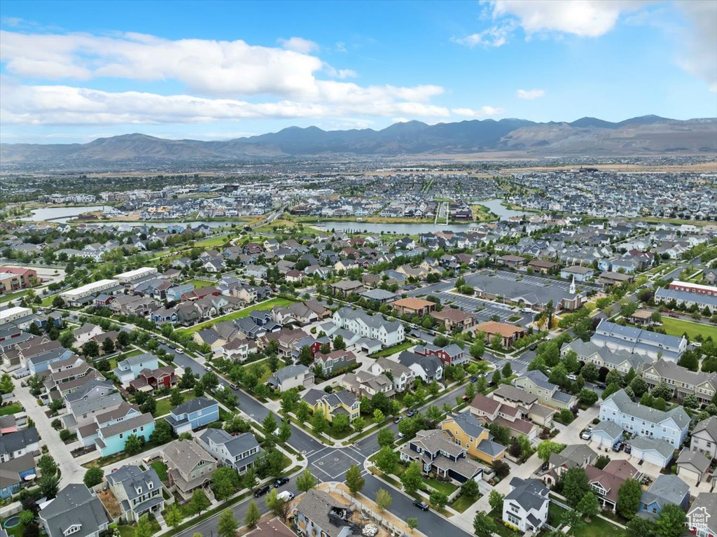 Aerial overview of property's location with a mountainous background and nearby suburban area