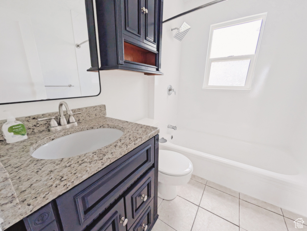 Full bath featuring vanity, shower / bathtub combination, and tile patterned flooring