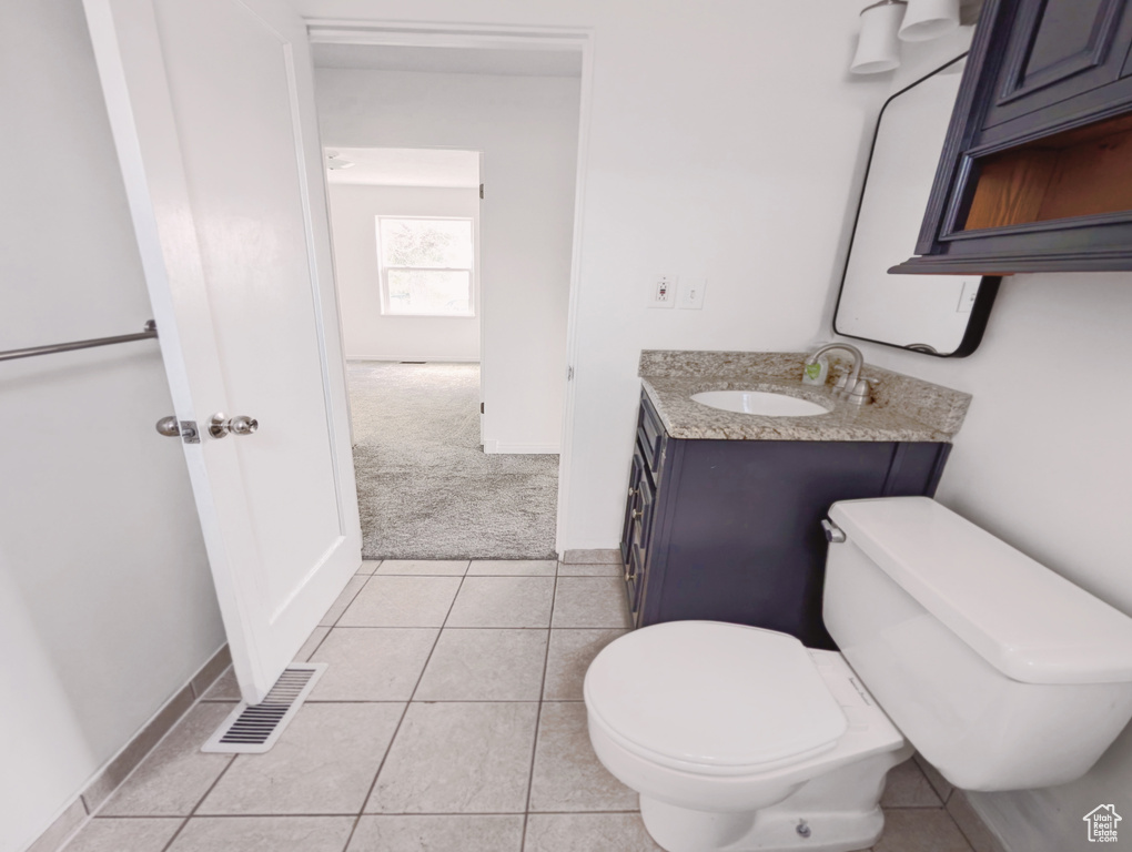 Half bath featuring vanity and tile patterned flooring