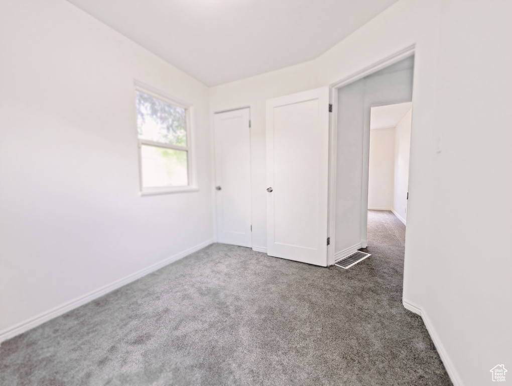 Unfurnished bedroom featuring carpet and baseboards