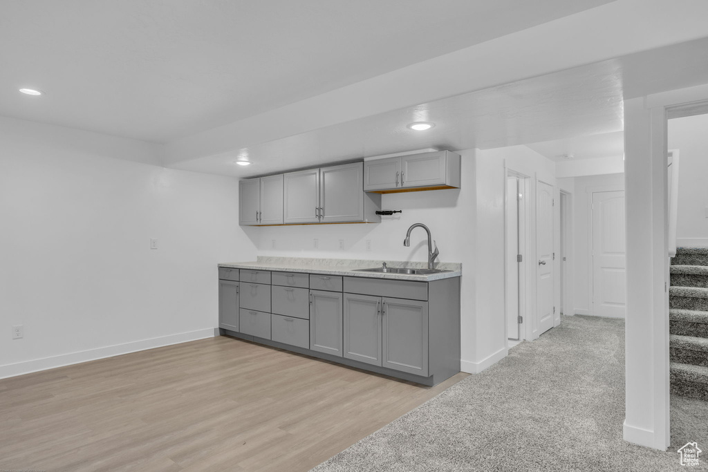 Kitchen with gray cabinets, recessed lighting, light countertops, and light wood-style floors