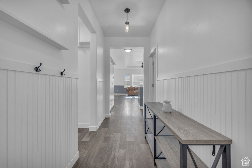 Hall featuring dark wood-type flooring and baseboards