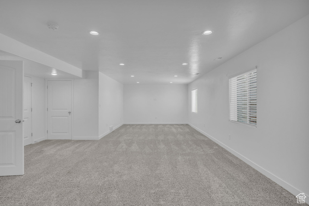 Unfurnished room with recessed lighting and light colored carpet
